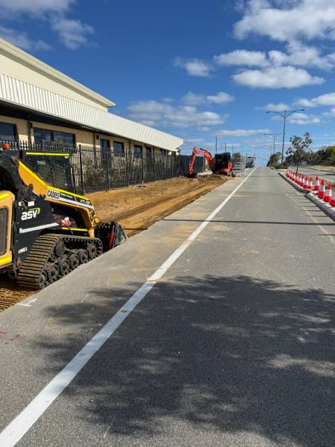 Skid steer working alongside a newly formed road verge